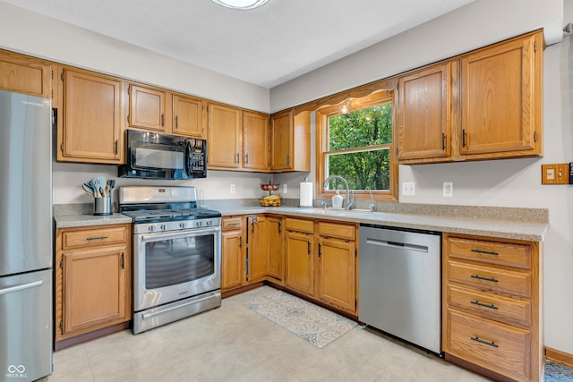 11534 Capistrano Cir, Indianapolis, IN 46236 - kitchen with stainless steel appliances, light countertops, and brown cabinets