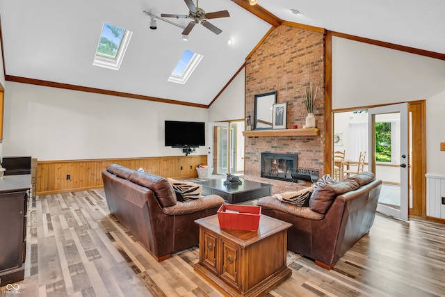 11534 Capistrano Cir, Indianapolis, IN 46236 - living room featuring high vaulted ceiling, a wainscoted wall, a ceiling fan, light wood-style flooring, and a fireplace