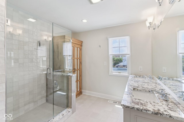1003 Alabama St, Indianapolis, IN 46202 - full bathroom with double vanity, a stall shower, tile patterned floors, and recessed lighting