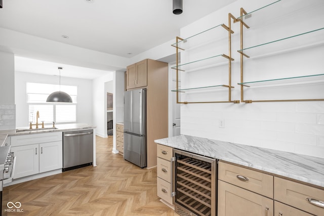 1003 Alabama St, Indianapolis, IN 46202 - kitchen featuring beverage cooler, appliances with stainless steel finishes, light stone counters, and hanging light fixtures