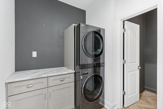 1003 Alabama St, Indianapolis, IN 46202 - washroom featuring stacked washer and clothes dryer and cabinet space