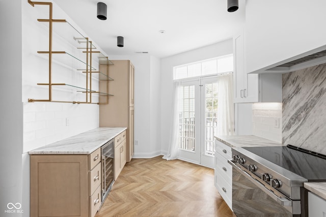 1003 Alabama St, Indianapolis, IN 46202 - kitchen featuring high end stainless steel range, beverage cooler, decorative backsplash, and light stone counters