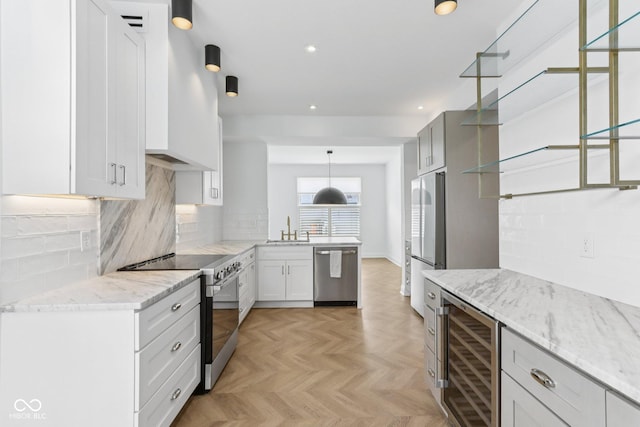1003 Alabama St, Indianapolis, IN 46202 - kitchen featuring stainless steel appliances, beverage cooler, a peninsula, light stone countertops, and decorative backsplash