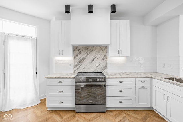 1003 Alabama St, Indianapolis, IN 46202 - kitchen with stainless steel range with electric stovetop, white cabinets, light stone countertops, and decorative backsplash