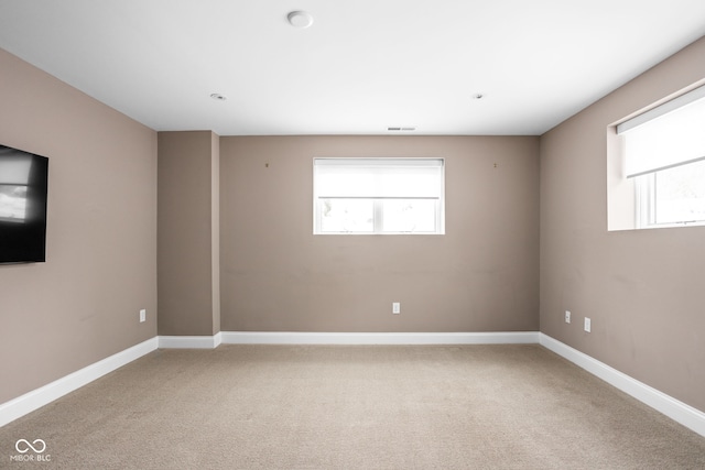 1003 Alabama St, Indianapolis, IN 46202 - empty room with healthy amount of natural light and light colored carpet