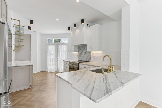 1003 Alabama St, Indianapolis, IN 46202 - kitchen with stainless steel appliances, light stone countertops, backsplash, a peninsula, and recessed lighting