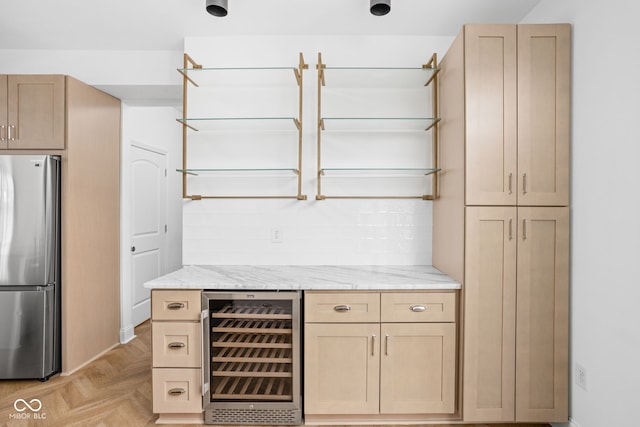 1003 Alabama St, Indianapolis, IN 46202 - kitchen with wine cooler, freestanding refrigerator, light stone countertops, light brown cabinets, and tasteful backsplash