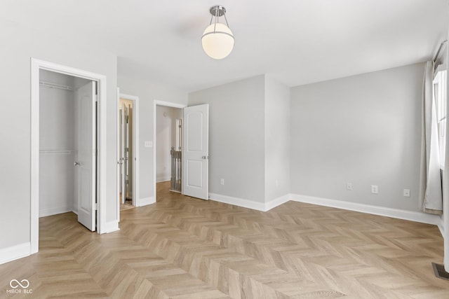 1003 Alabama St, Indianapolis, IN 46202 - unfurnished bedroom featuring a walk in closet and baseboards