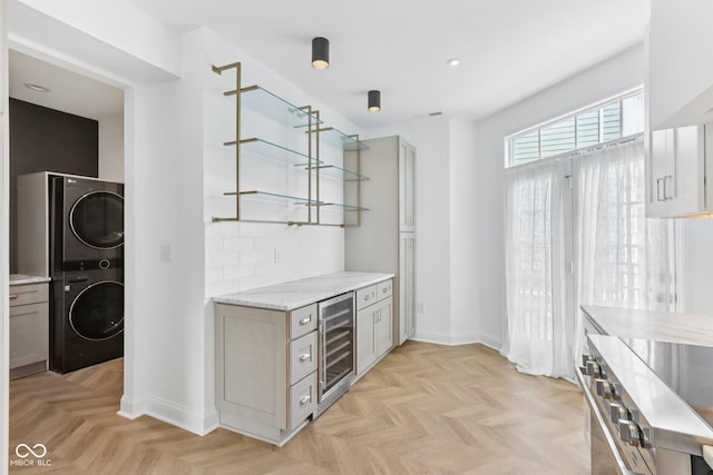 1003 Alabama St, Indianapolis, IN 46202 - kitchen featuring stacked washer / drying machine, open shelves, beverage cooler, gray cabinets, and recessed lighting