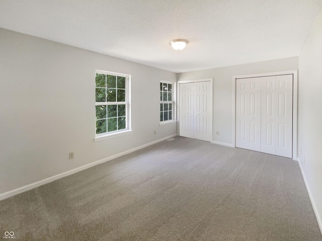 81 Brookland Ln, Pittsboro, IN 46167 - unfurnished bedroom with two closets and carpet flooring