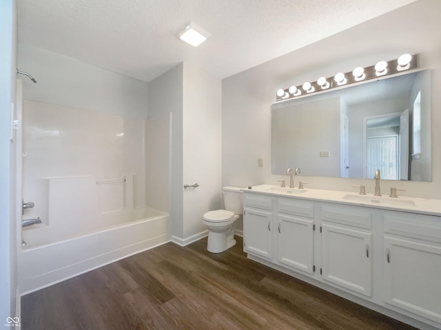 81 Brookland Ln, Pittsboro, IN 46167 - bathroom featuring wood finished floors, double vanity, tub / shower combination, and a textured ceiling