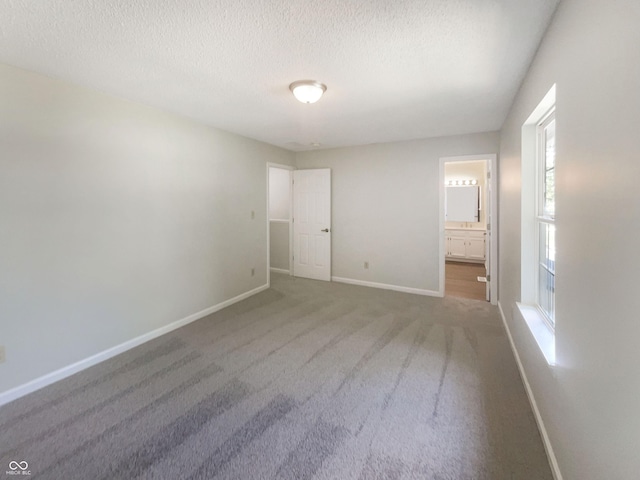 81 Brookland Ln, Pittsboro, IN 46167 - unfurnished bedroom featuring a textured ceiling, carpet floors, and connected bathroom