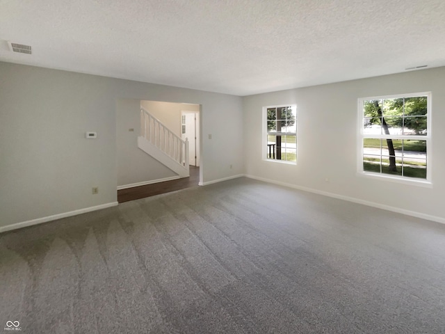 81 Brookland Ln, Pittsboro, IN 46167 - empty room with carpet floors, stairway, and a textured ceiling