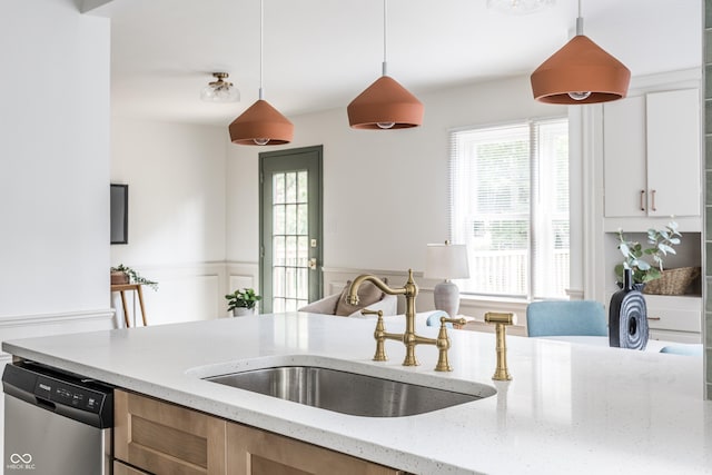 316 Ohmer Ave, Indianapolis, IN 46219 - kitchen featuring dishwasher, hanging light fixtures, light stone countertops, a wainscoted wall, and white cabinetry