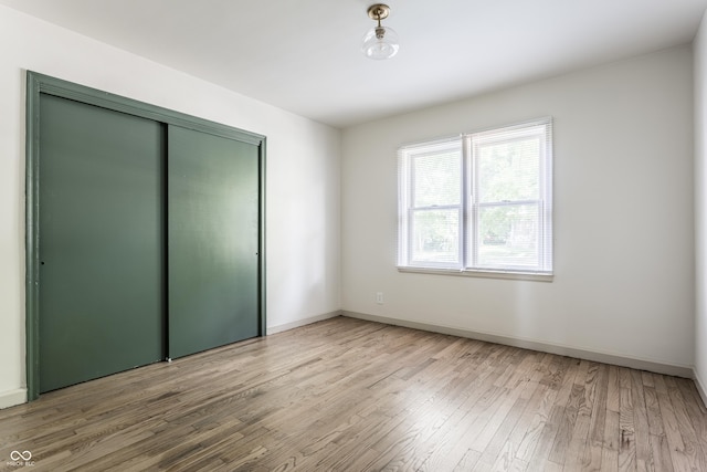 316 Ohmer Ave, Indianapolis, IN 46219 - unfurnished bedroom with light wood-type flooring and a closet