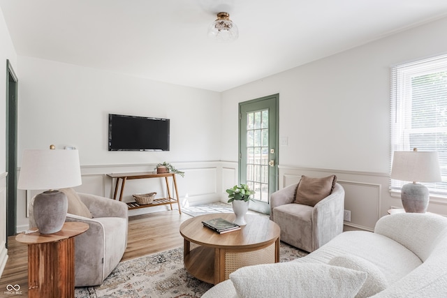 316 Ohmer Ave, Indianapolis, IN 46219 - living area featuring healthy amount of natural light, light wood-type flooring, wainscoting, and a decorative wall