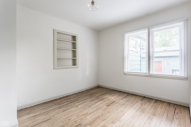 316 Ohmer Ave, Indianapolis, IN 46219 - empty room featuring light wood-style flooring and built in shelves