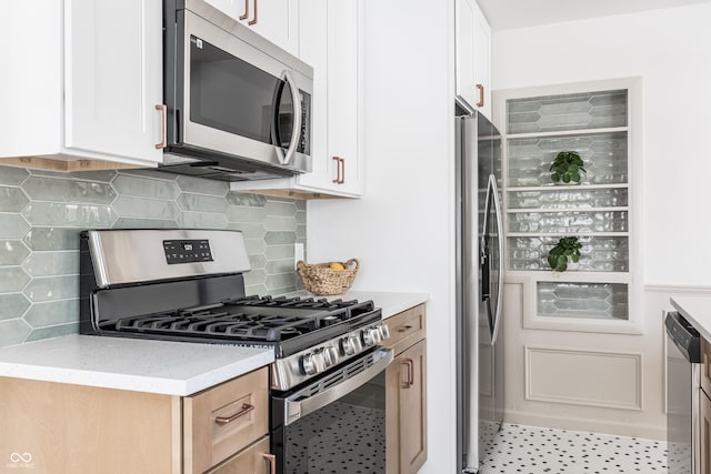 316 Ohmer Ave, Indianapolis, IN 46219 - kitchen with stainless steel appliances, white cabinets, light stone countertops, and backsplash