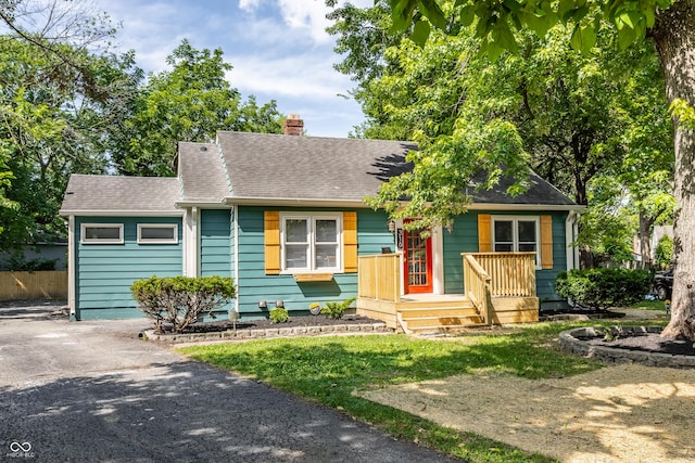 316 Ohmer Ave, Indianapolis, IN 46219 - view of front facade with a chimney and a shingled roof