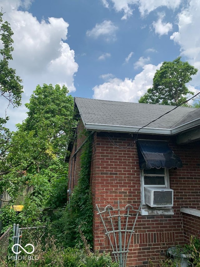 4547 Zoeller Ave, Indianapolis, IN 46226 - view of side of home with brick siding, roof with shingles, and cooling unit