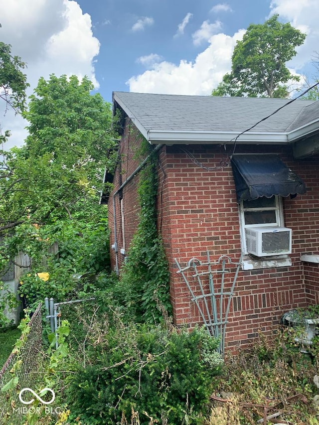 4547 Zoeller Ave, Indianapolis, IN 46226 - view of side of property with brick siding, cooling unit, and roof with shingles