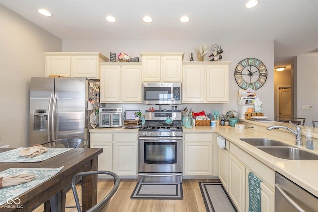 4285 Washington Blvd, Plainfield, IN 46168 - kitchen featuring appliances with stainless steel finishes, light countertops, light wood-style floors, and recessed lighting