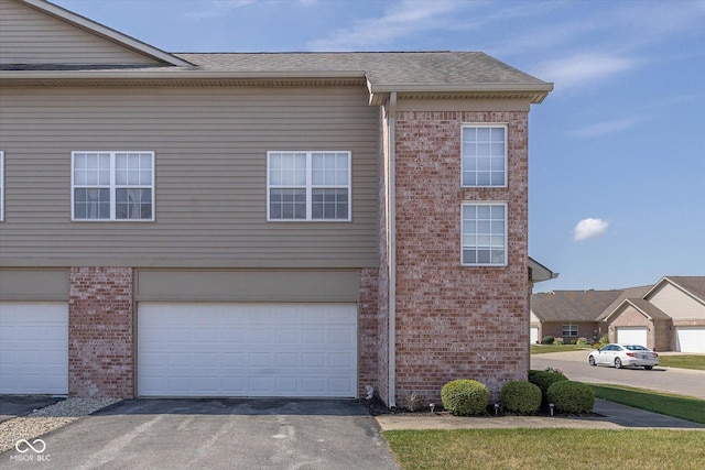 4285 Washington Blvd, Plainfield, IN 46168 - view of side of home with driveway, brick siding, and an attached garage
