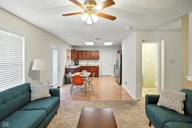 2421 Amberleigh Dr, Plainfield, IN 46168 - living area featuring light carpet, a ceiling fan, and light wood-type flooring