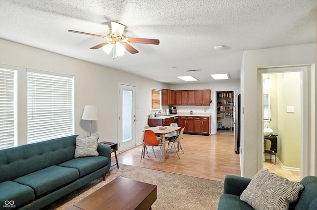 2421 Amberleigh Dr, Plainfield, IN 46168 - living room featuring light carpet, a ceiling fan, and a textured ceiling