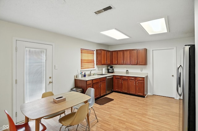 2421 Amberleigh Dr, Plainfield, IN 46168 - kitchen with stainless steel appliances, light countertops, light wood finished floors, and brown cabinets