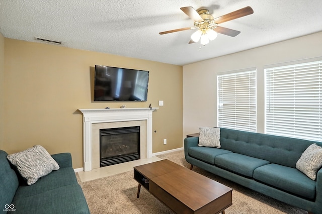 2421 Amberleigh Dr, Plainfield, IN 46168 - living room with carpet, a ceiling fan, a fireplace with flush hearth, and a textured ceiling