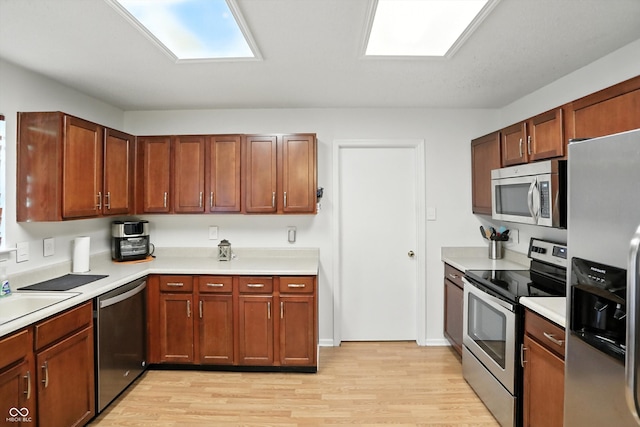 2421 Amberleigh Dr, Plainfield, IN 46168 - kitchen with appliances with stainless steel finishes, light wood-style flooring, and light countertops