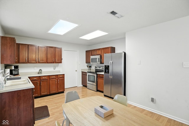 2421 Amberleigh Dr, Plainfield, IN 46168 - kitchen with appliances with stainless steel finishes, light wood-type flooring, and light countertops