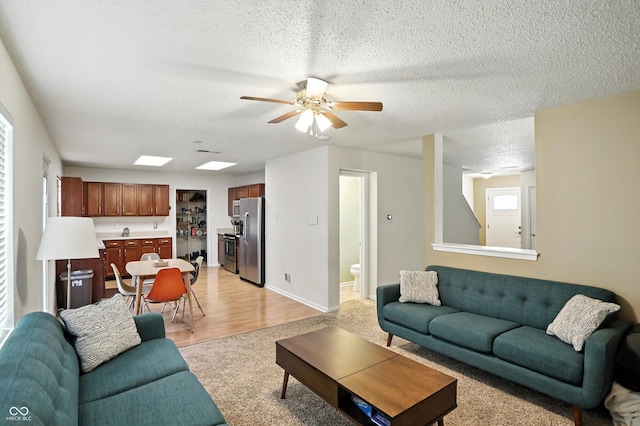 2421 Amberleigh Dr, Plainfield, IN 46168 - living room with ceiling fan, a textured ceiling, and light colored carpet