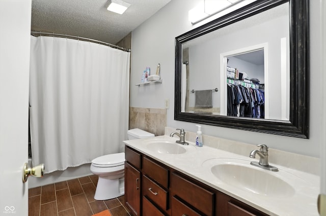 2421 Amberleigh Dr, Plainfield, IN 46168 - bathroom with double vanity, a textured ceiling, and shower / bathtub combination with curtain