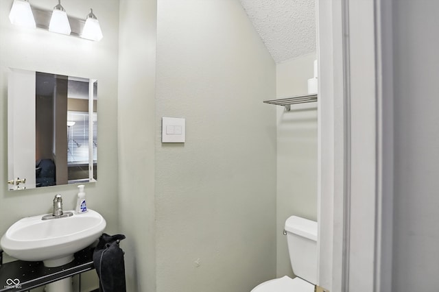 2421 Amberleigh Dr, Plainfield, IN 46168 - half bathroom featuring a sink and a textured ceiling