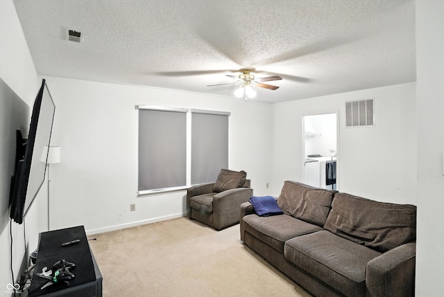2421 Amberleigh Dr, Plainfield, IN 46168 - carpeted living area with ceiling fan, washer / dryer, and a textured ceiling