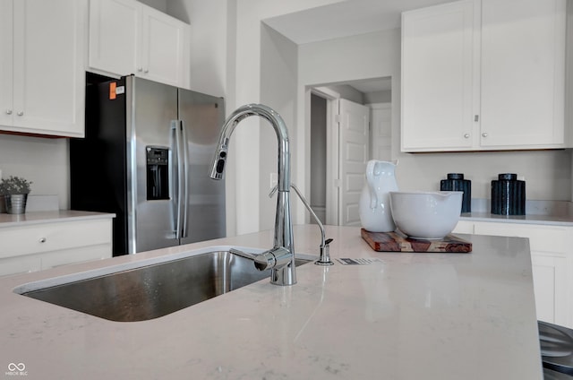 6655 Halsey St, Zionsville, IN 46077 - kitchen featuring stainless steel refrigerator with ice dispenser, white cabinets, and light stone counters