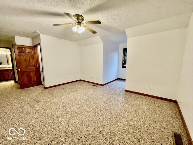 35 Northridge Ct, Brownsburg, IN 46112 - spare room featuring a ceiling fan, a textured ceiling, light colored carpet, and vaulted ceiling