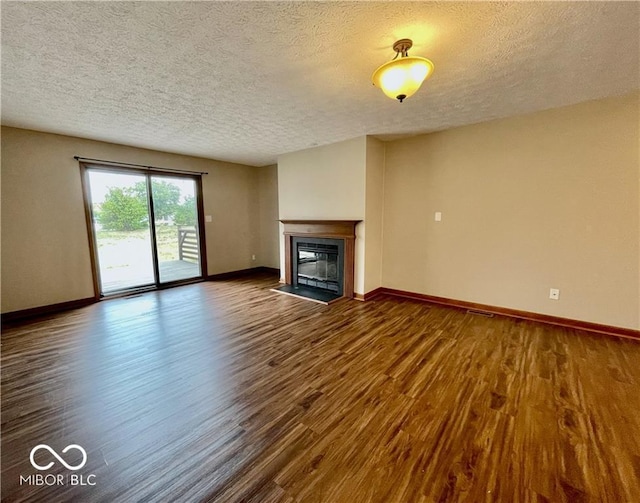 35 Northridge Ct, Brownsburg, IN 46112 - unfurnished living room with a textured ceiling, dark wood finished floors, and a glass covered fireplace