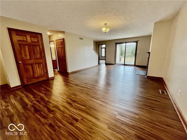 35 Northridge Ct, Brownsburg, IN 46112 - unfurnished living room featuring dark wood-style flooring and a textured ceiling