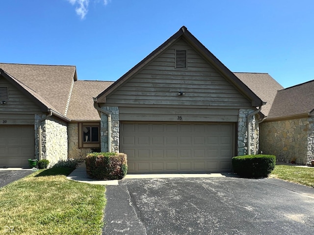 35 Northridge Ct, Brownsburg, IN 46112 - ranch-style house with stone siding, asphalt driveway, and roof with shingles