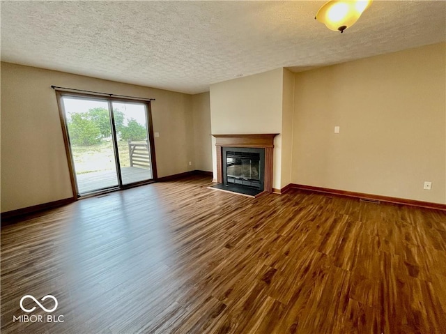 35 Northridge Ct, Brownsburg, IN 46112 - unfurnished living room featuring a textured ceiling, dark wood-style flooring, and a fireplace with flush hearth