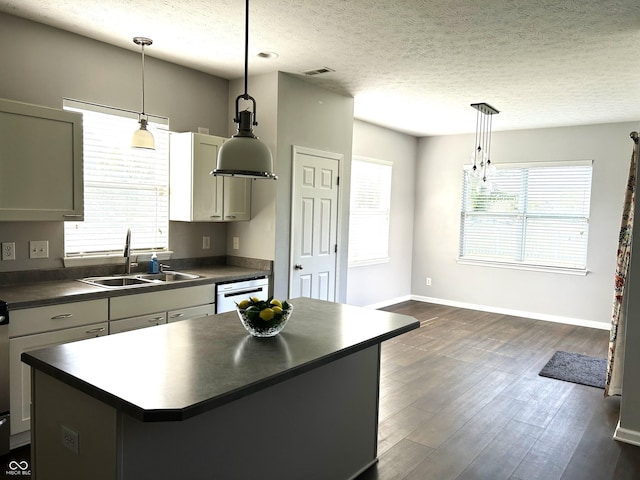 8287 Falkirk Dr, Avon, IN 46123 - kitchen with dark countertops, a center island, dark wood-type flooring, dishwasher, and a textured ceiling