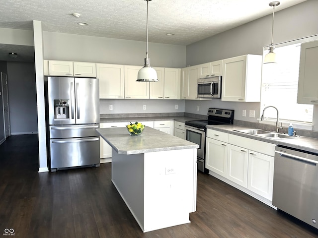 8287 Falkirk Dr, Avon, IN 46123 - kitchen featuring stainless steel appliances, a textured ceiling, dark wood-type flooring, and white cabinetry