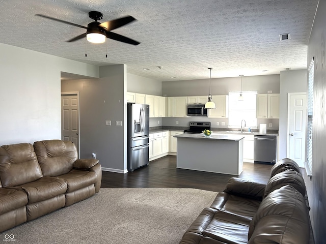 8287 Falkirk Dr, Avon, IN 46123 - living room with dark wood-style flooring, ceiling fan, and a textured ceiling