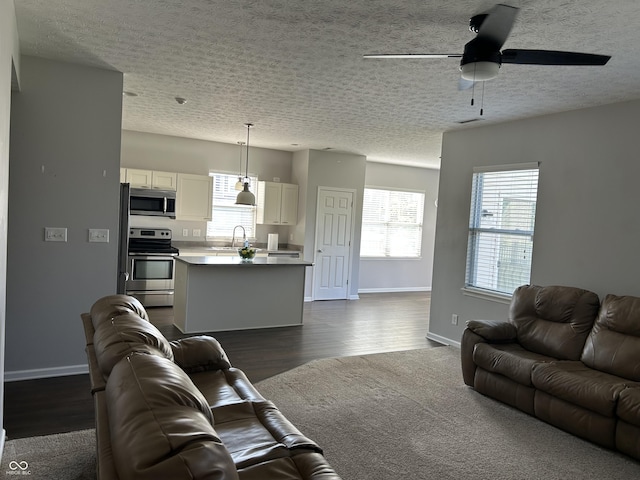 8287 Falkirk Dr, Avon, IN 46123 - living area featuring ceiling fan, dark wood-style flooring, and a textured ceiling