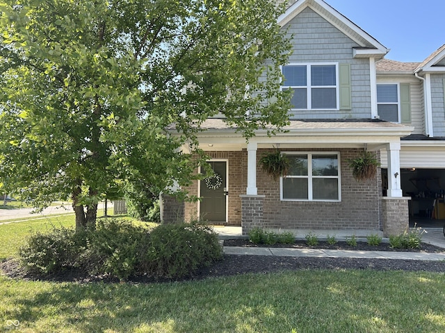 8287 Falkirk Dr, Avon, IN 46123 - craftsman-style house with a porch, a front yard, brick siding, and a garage