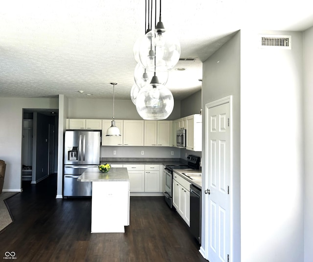 8287 Falkirk Dr, Avon, IN 46123 - kitchen featuring appliances with stainless steel finishes, a kitchen island, dark wood-style floors, hanging light fixtures, and white cabinets