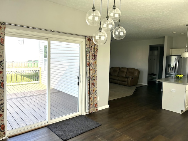 8287 Falkirk Dr, Avon, IN 46123 - doorway to outside featuring dark wood finished floors and a textured ceiling